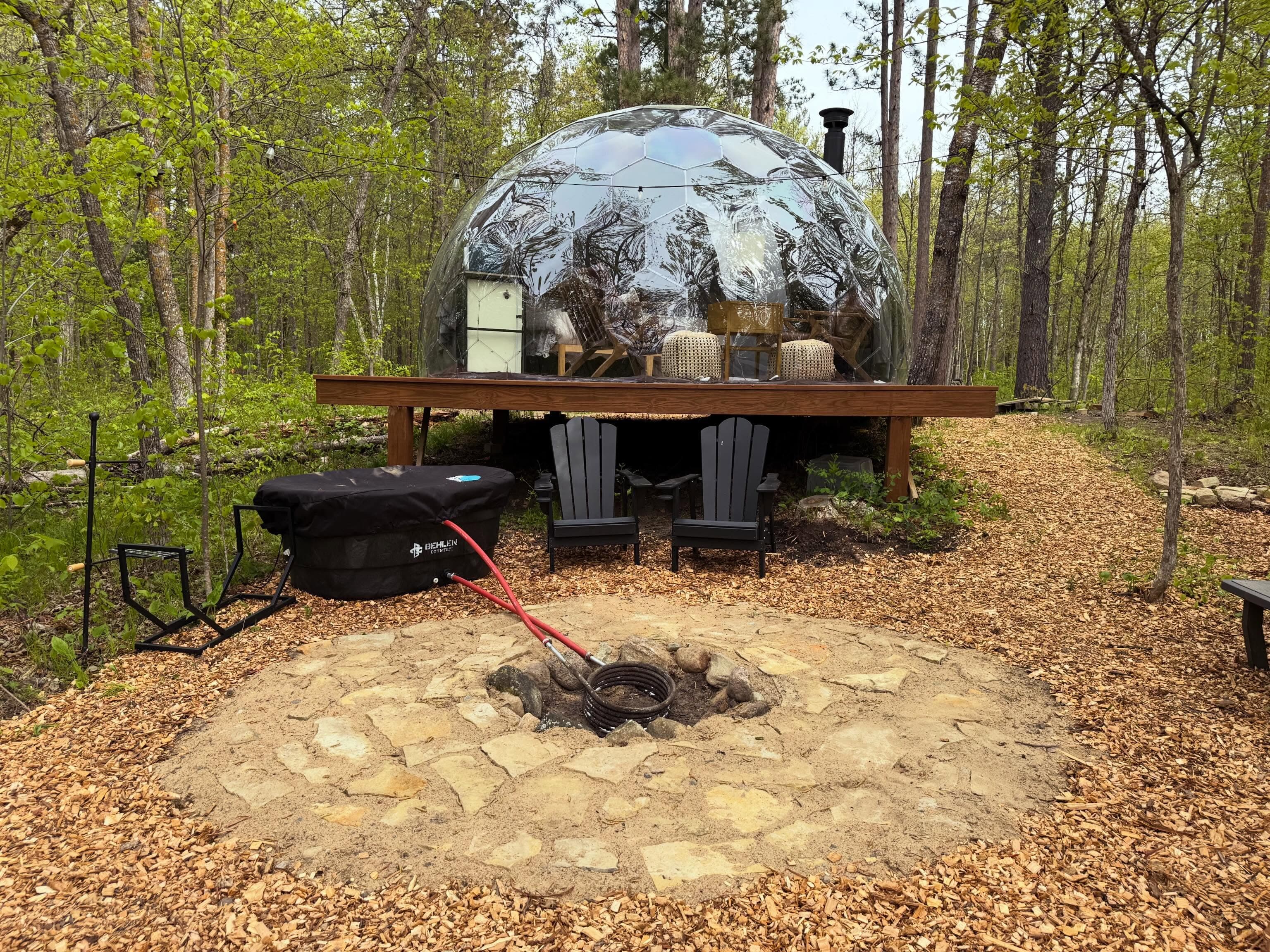 Geodesic mirror dome surrounded by forest at Cuyuna Crossing
